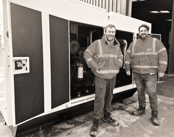 An image of the Target Tool and Generator hire directors infront of a diesel generator.